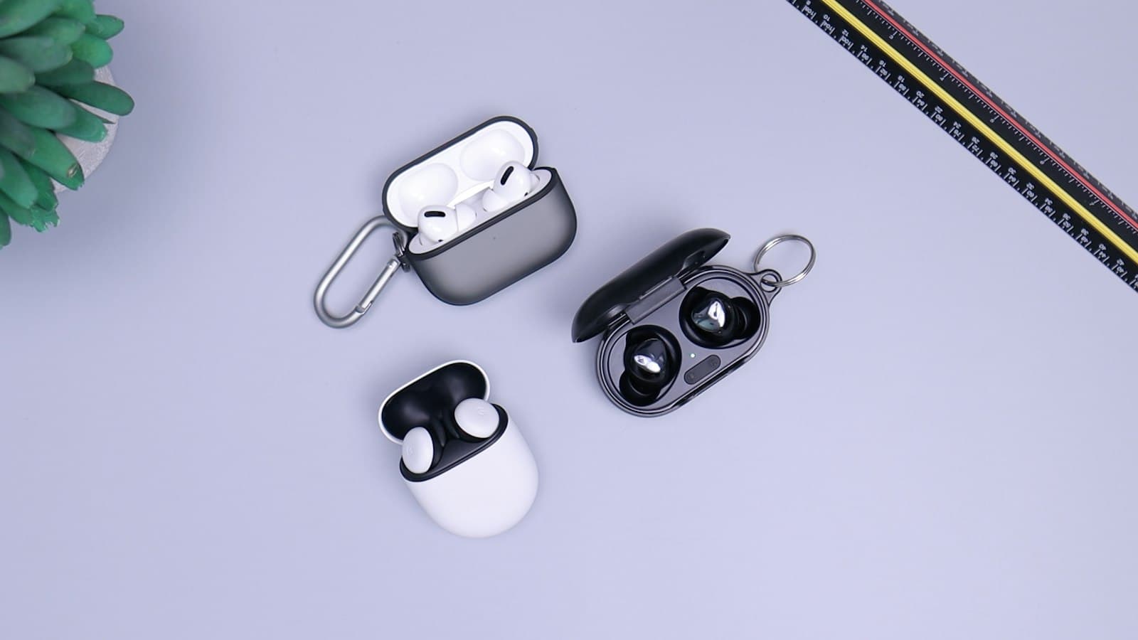 Compact wireless earbuds in an open charging case on a wooden desk